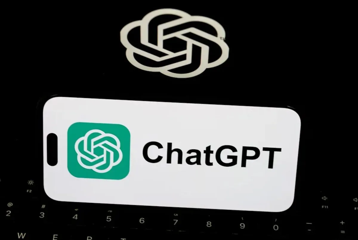 ChatGPT logo on a teal app icon next to the text 'ChatGPT' on a white rounded card over a dark keyboard background.