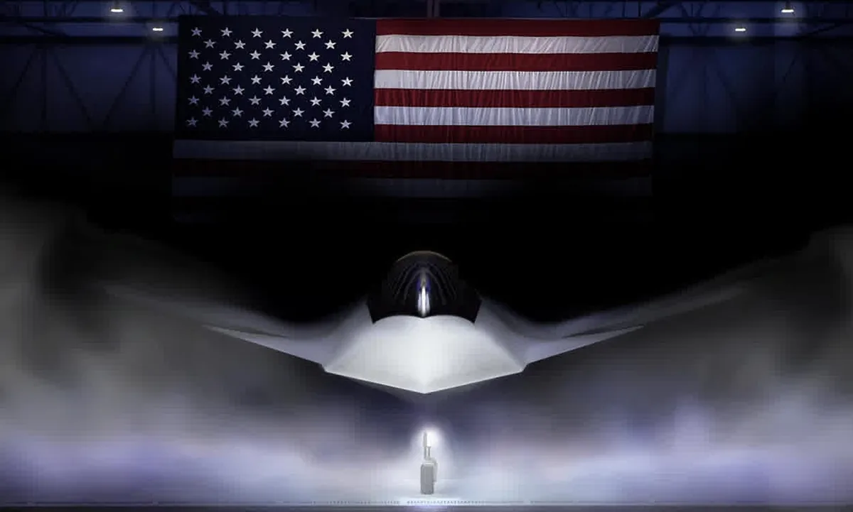 A sleek, futuristic aircraft in a foggy hangar with a large American flag hanging above.
