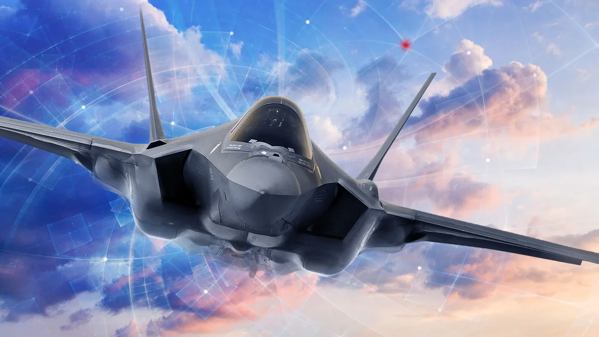 Front view of a gray stealth fighter jet in flight, with a digital network overlay of lines and nodes in a blue sky with pink clouds behind it.